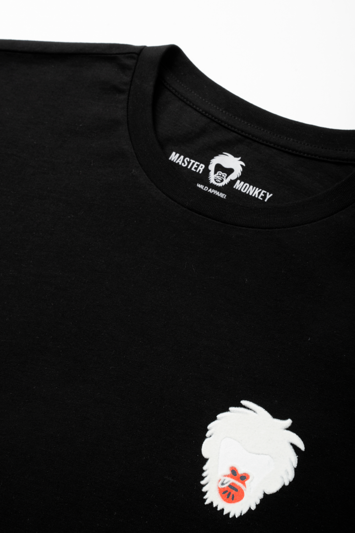 Black t-shirt with a white embroidered design and Master Monkey branding on a white background #color_black