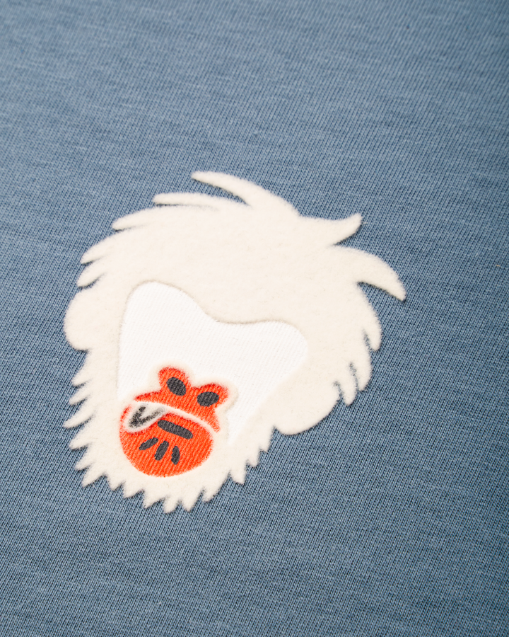 Embroidered Master Monkey design on a blue fabric background #color_steel-blue