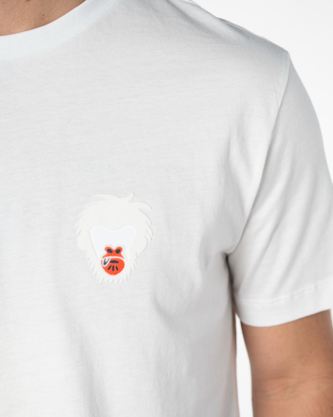 White t-shirt with a small Master Monkey logo on the chest against a white background #color_white