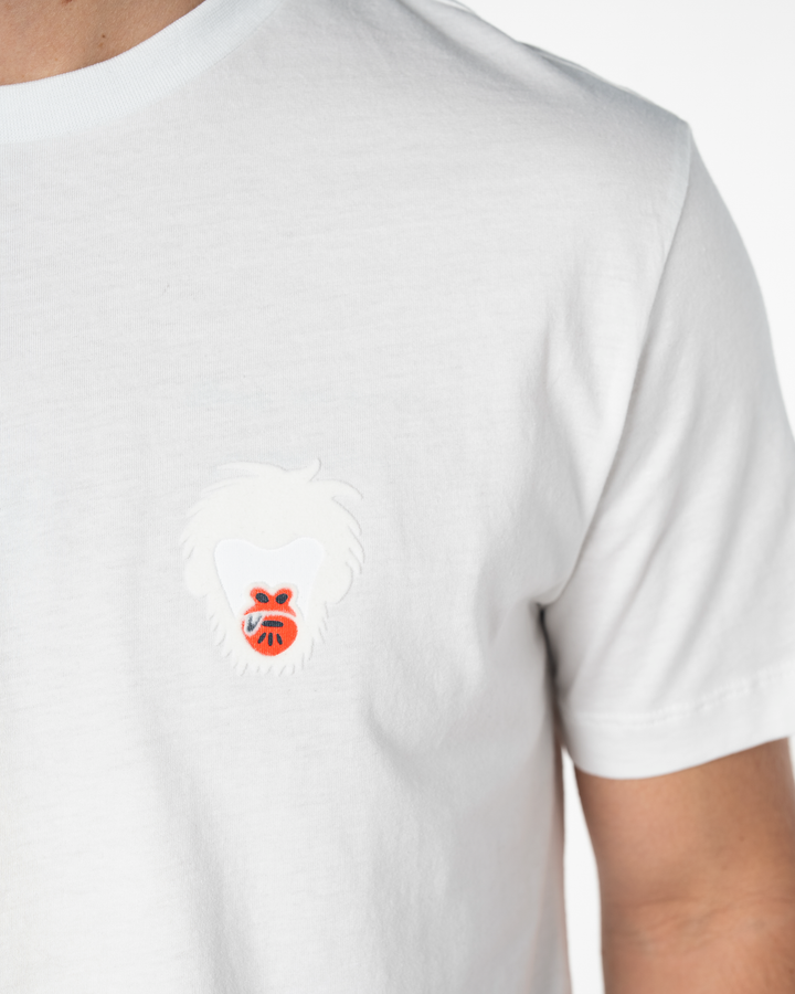 White t-shirt with a small Master Monkey logo on the chest against a white background #color_white
