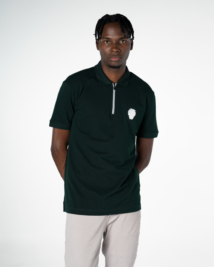 Man wearing a dark green polo shirt with a reflective logo on a white background  #color_gunmetal-green