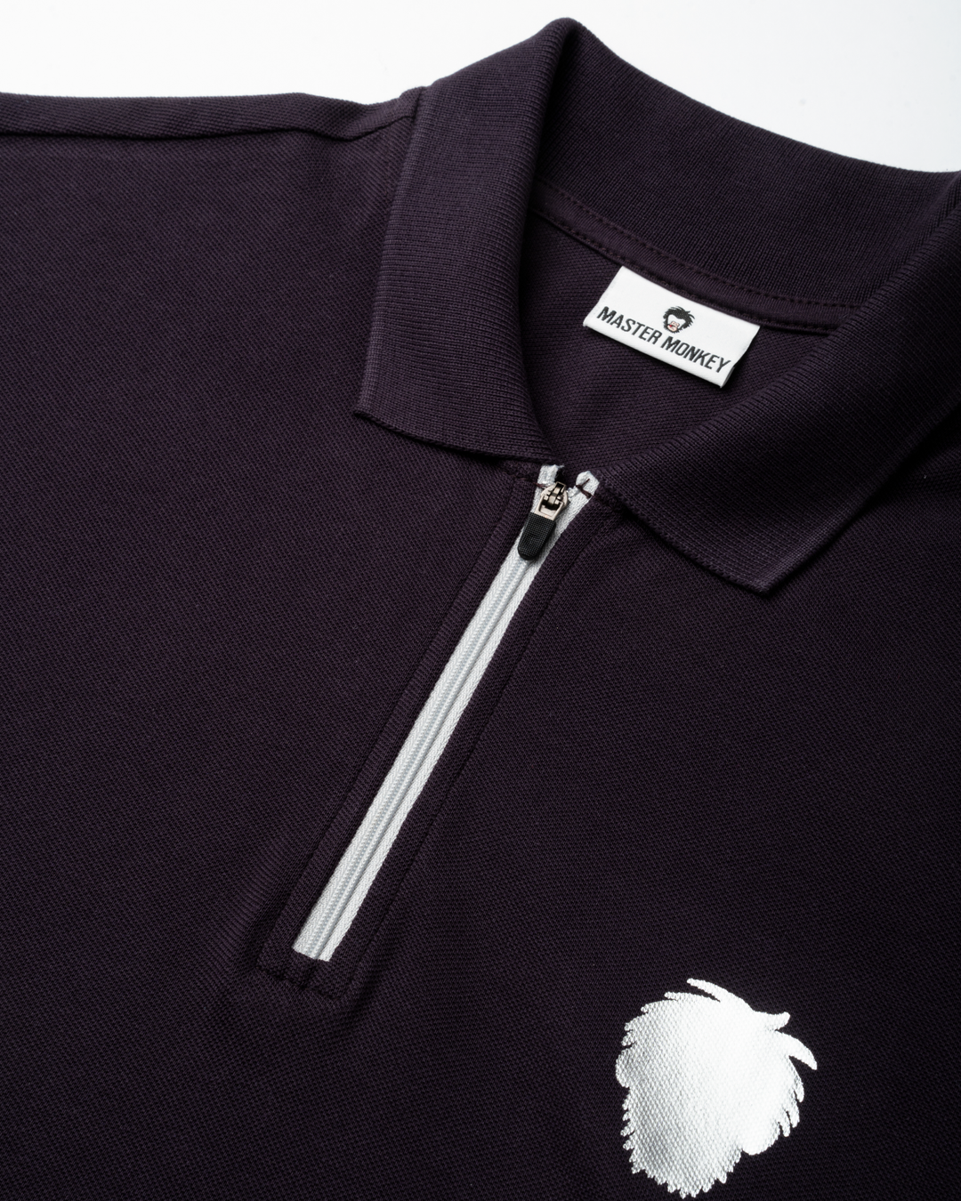 Black polo shirt with a white zipper and logo on a white background #color_lead