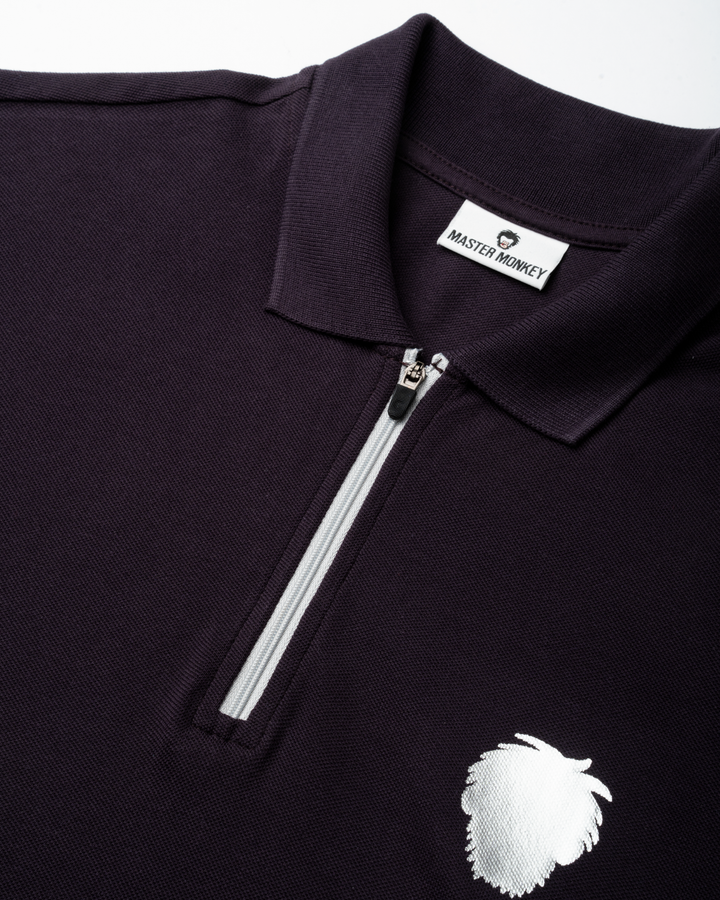 Black polo shirt with a white zipper and logo on a white background #color_lead