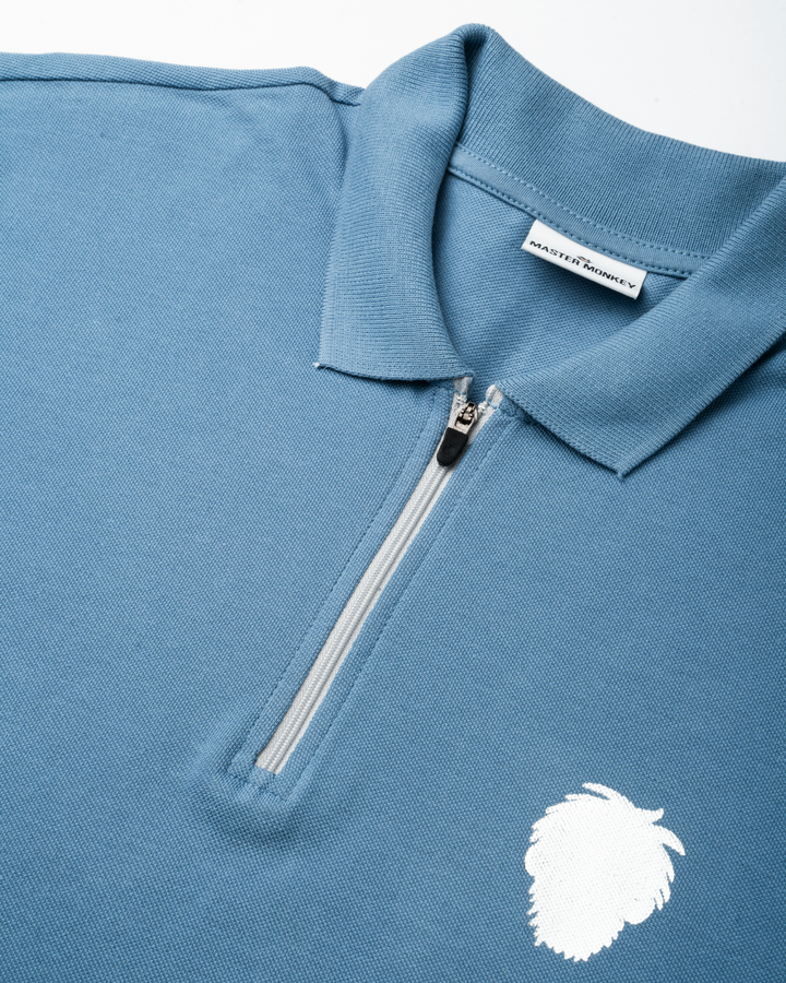Blue polo shirt with a reflective logo on a white background #color_steel-blue
