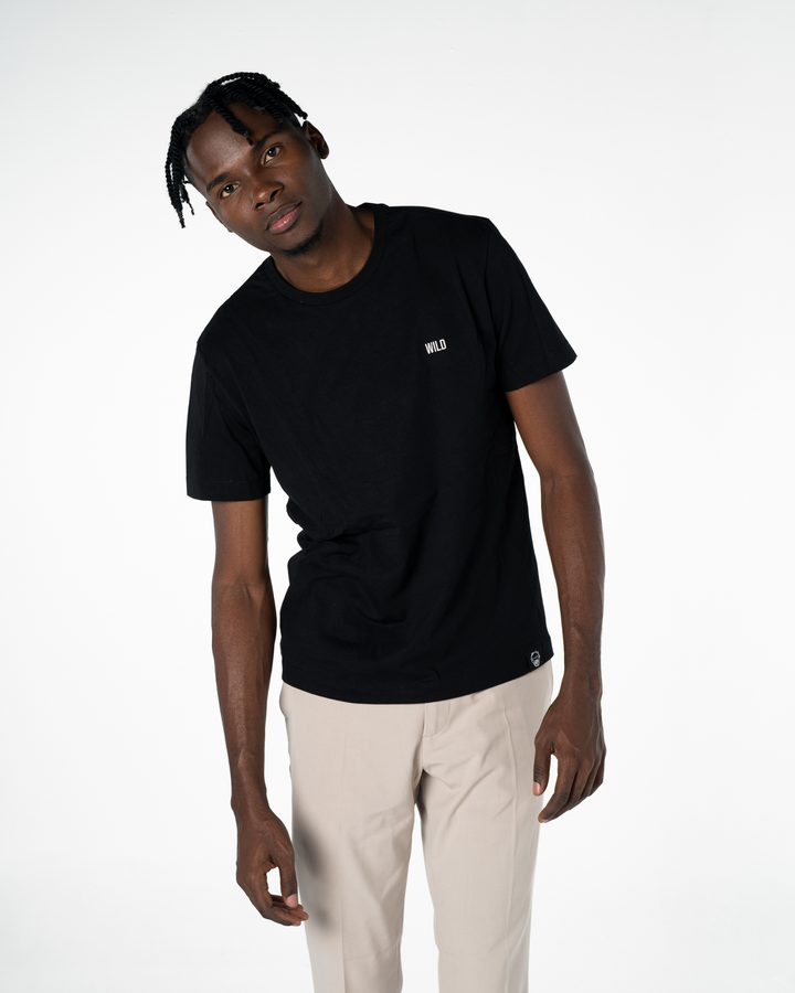 Man wearing a black t-shirt with a logo on a white background #color_black