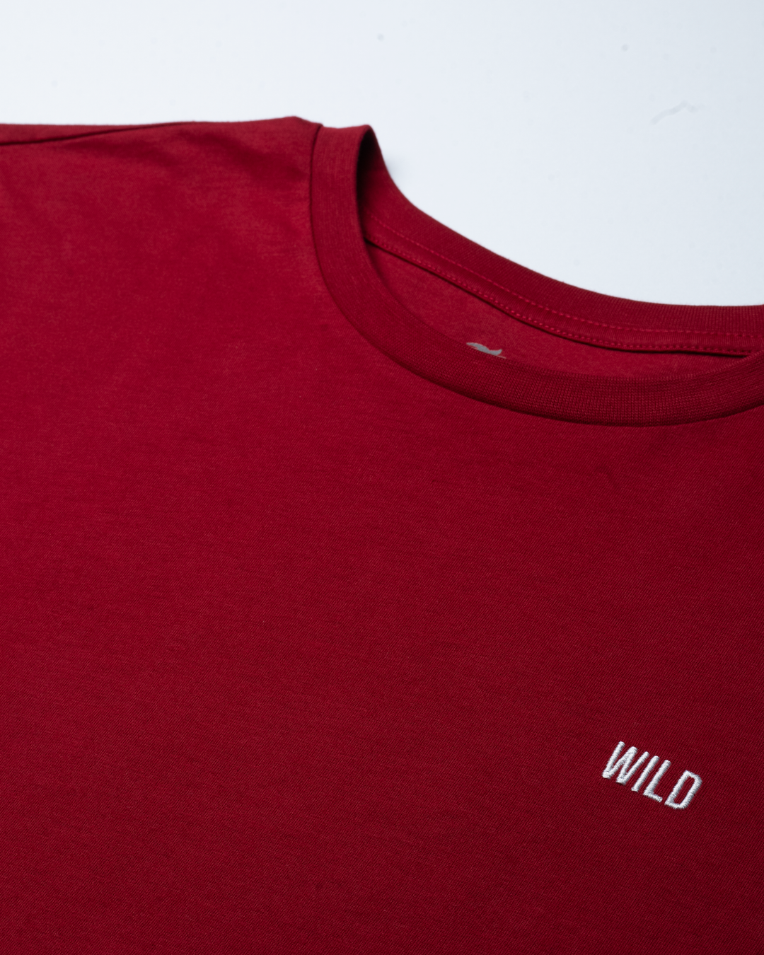 Red t-shirt with 'WILD' logo on a white background #color_brick