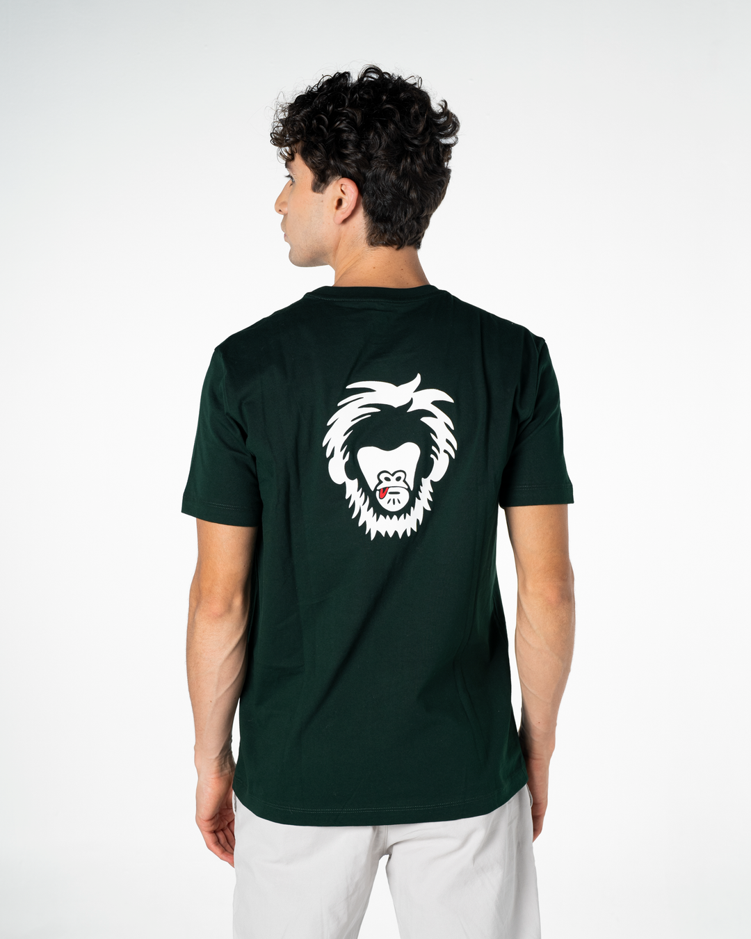 Person wearing a green t-shirt with a white monkey graphic on the back, standing against a white background
#color_gunmetal-green