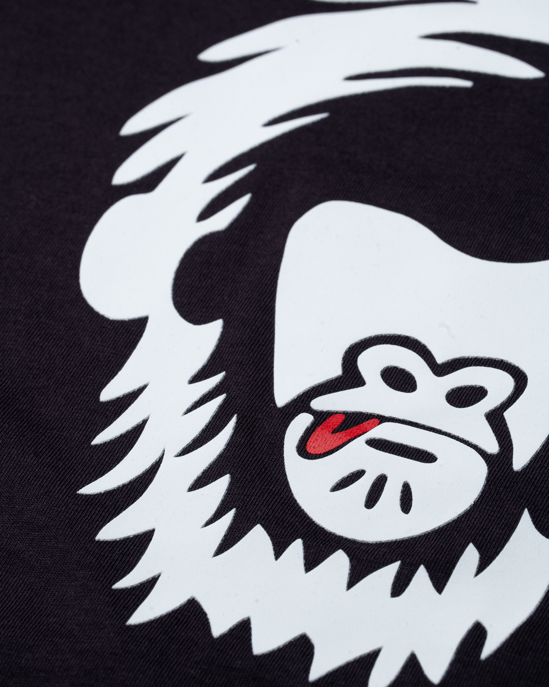 White logo with a red tongue on a purple grey background #color_lead