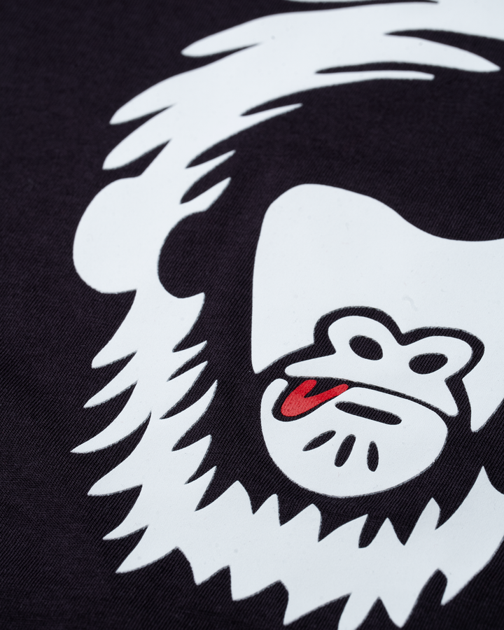 White logo with a red tongue on a purple grey background #color_lead