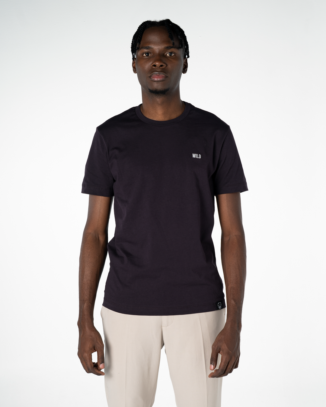 Person wearing a black t-shirt with a logo on a white background #color_lead