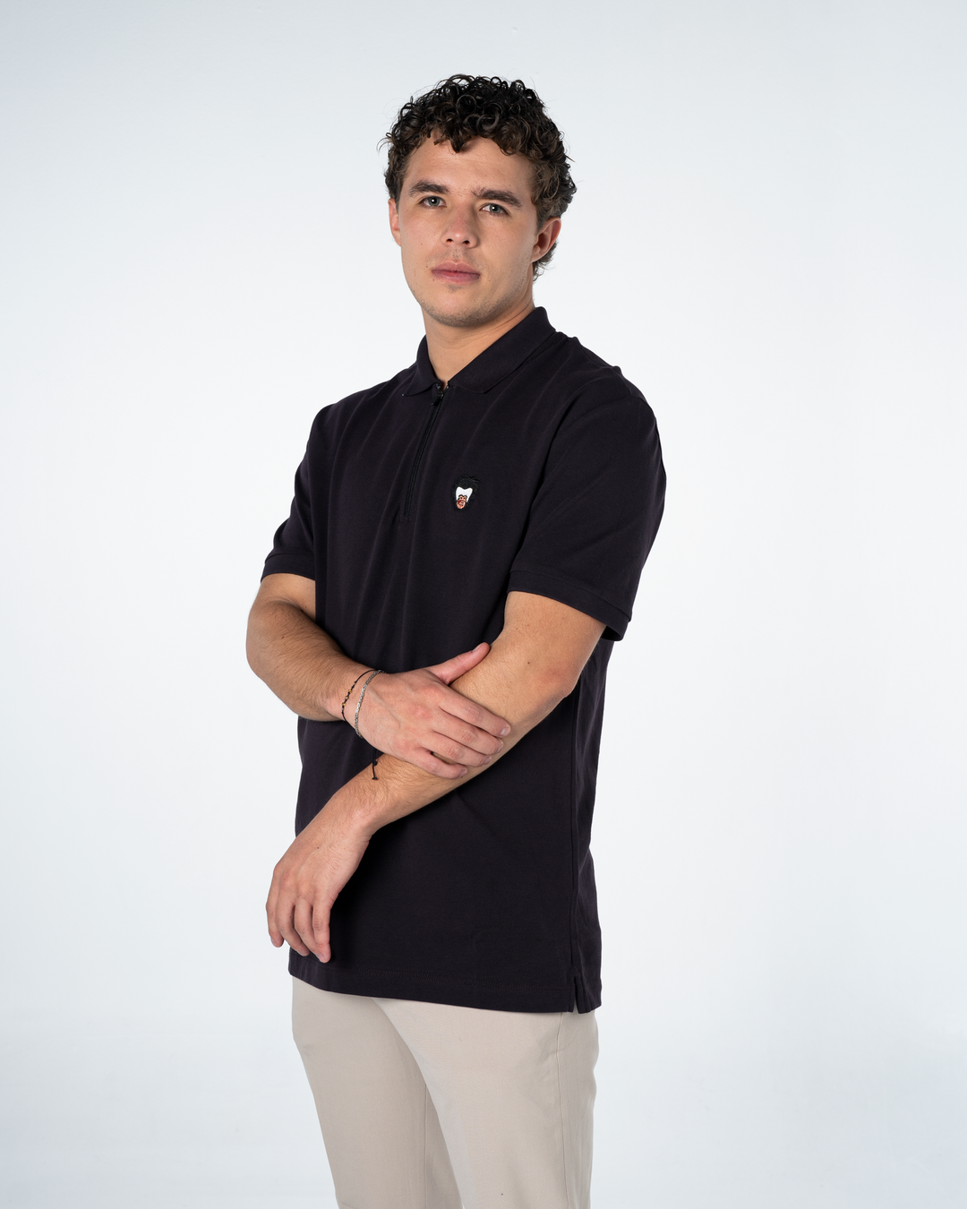 Model is wearing a Master Monkey dark purple polo with the iconic monkey logo on the wearer's chest #color_lead