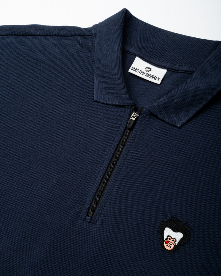 Blue collared shirt with master monkey logo in the wearer's left chest  #color_midnight