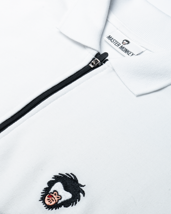 Close up of Master Monkey polo in White. #color_white
