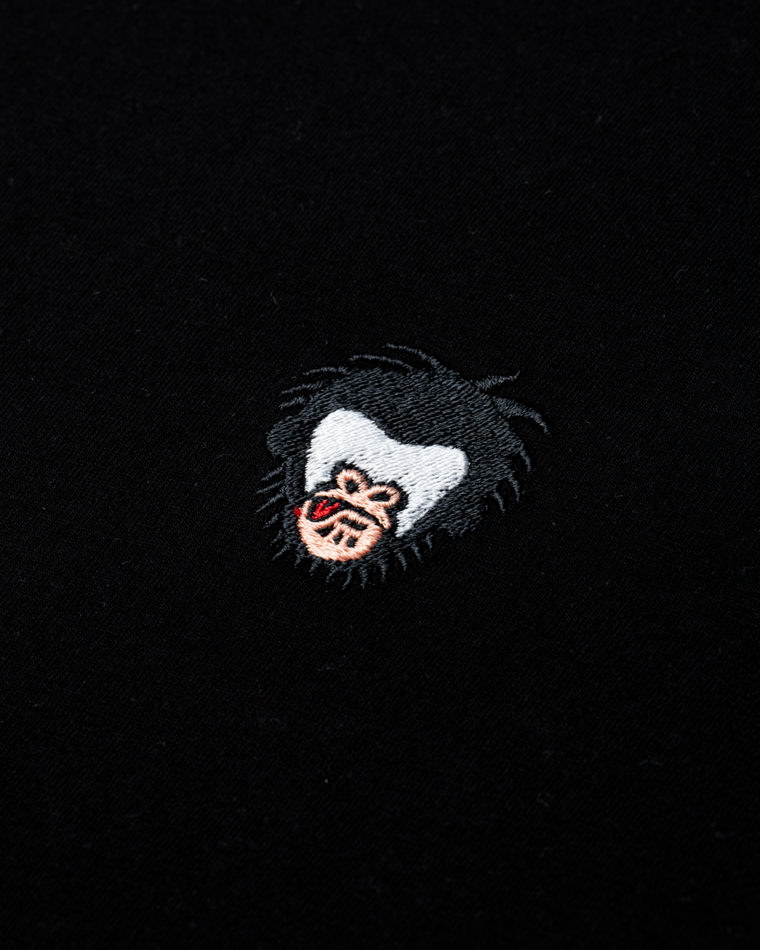 Embroidered patch of the Master Monkey logo on a black background #color_black