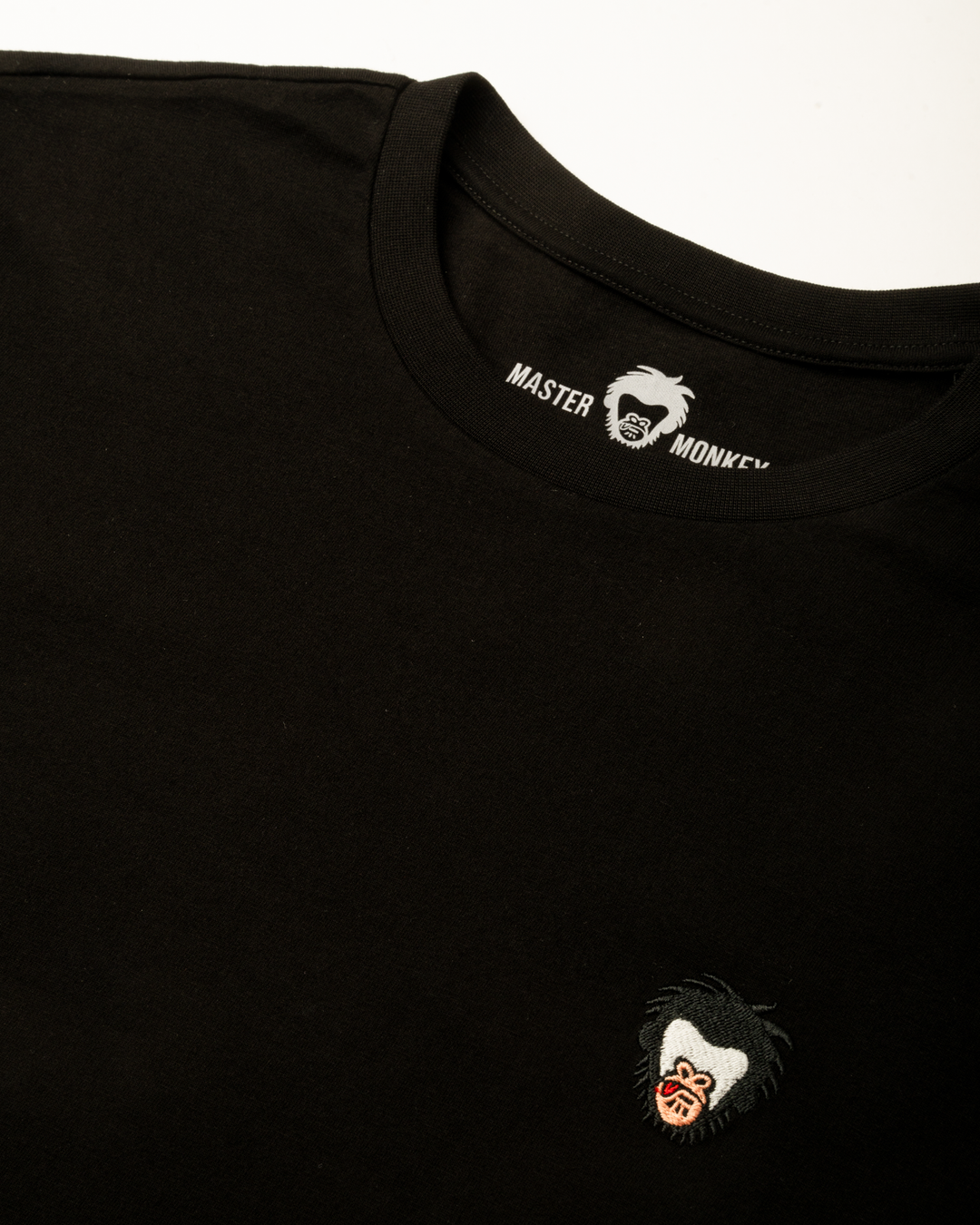 Black t-shirt with the Master Monkey logo on the chest and brand name on the collar #color_black