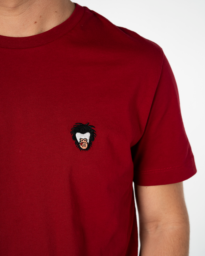 Red t-shirt with a small embroidered Master Monkey logo on a white background #color_brick