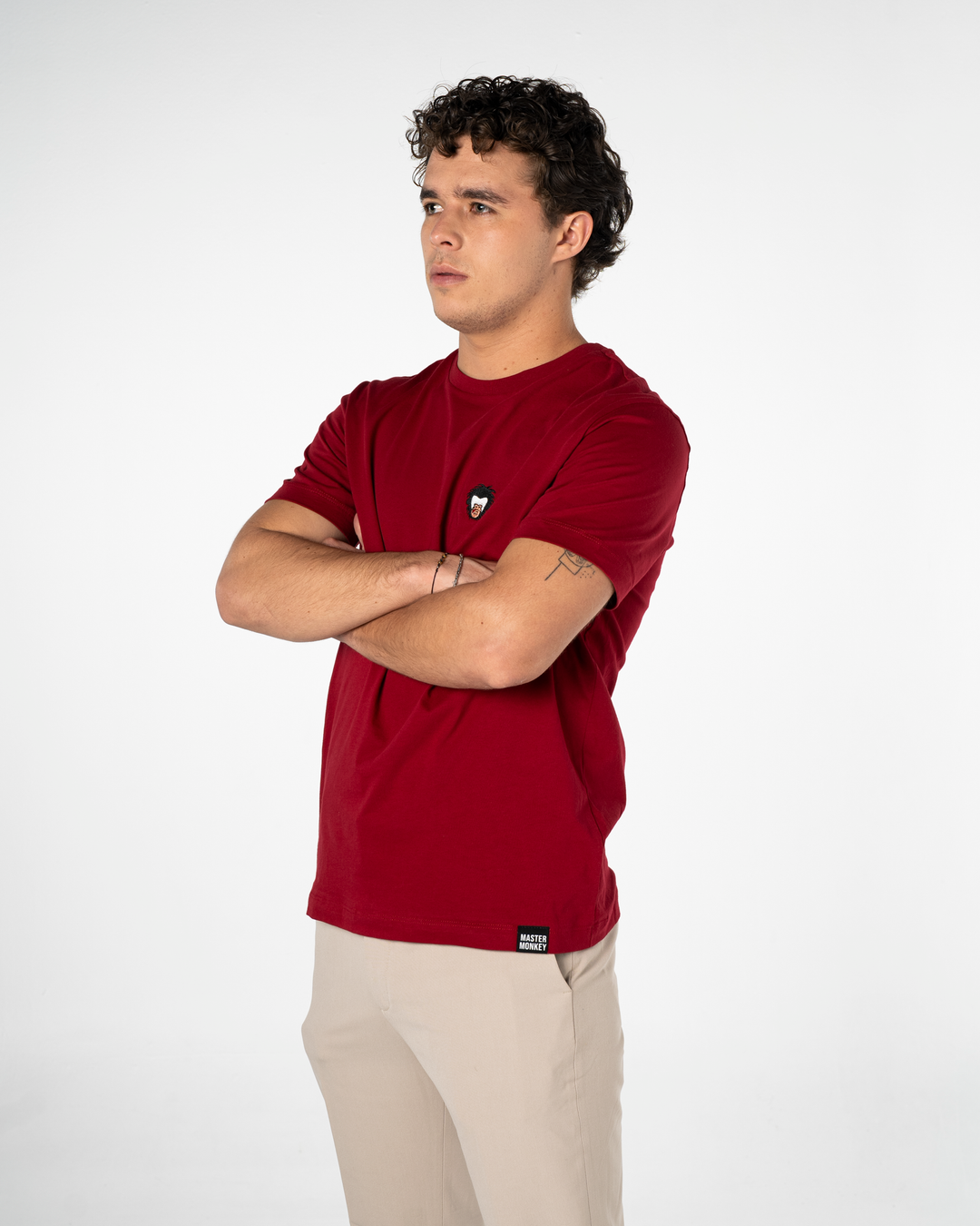 Person wearing a red t-shirt with the Master Monkey logo on a white background #color_brick