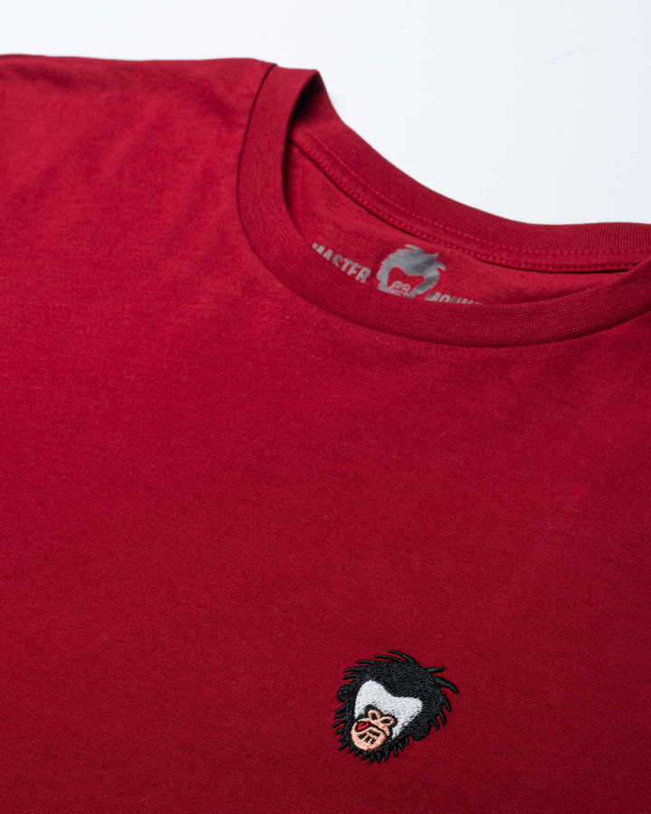 Red t-shirt with the Master Monkey logo on the chest against a white background #color_brick