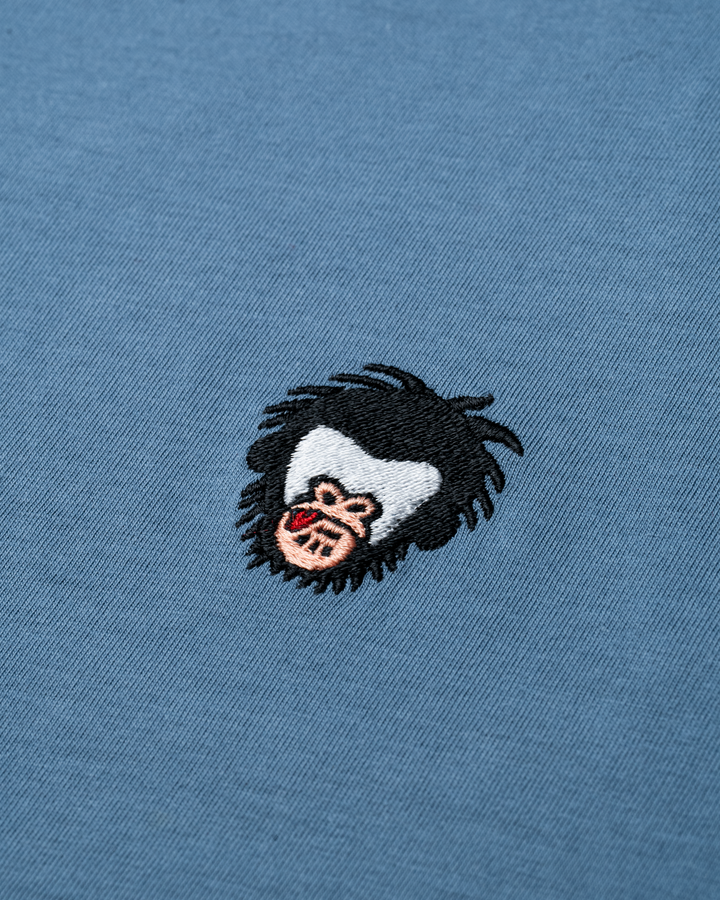 Embroidered Master Monkey design on a blue fabric background #color_steel-blue