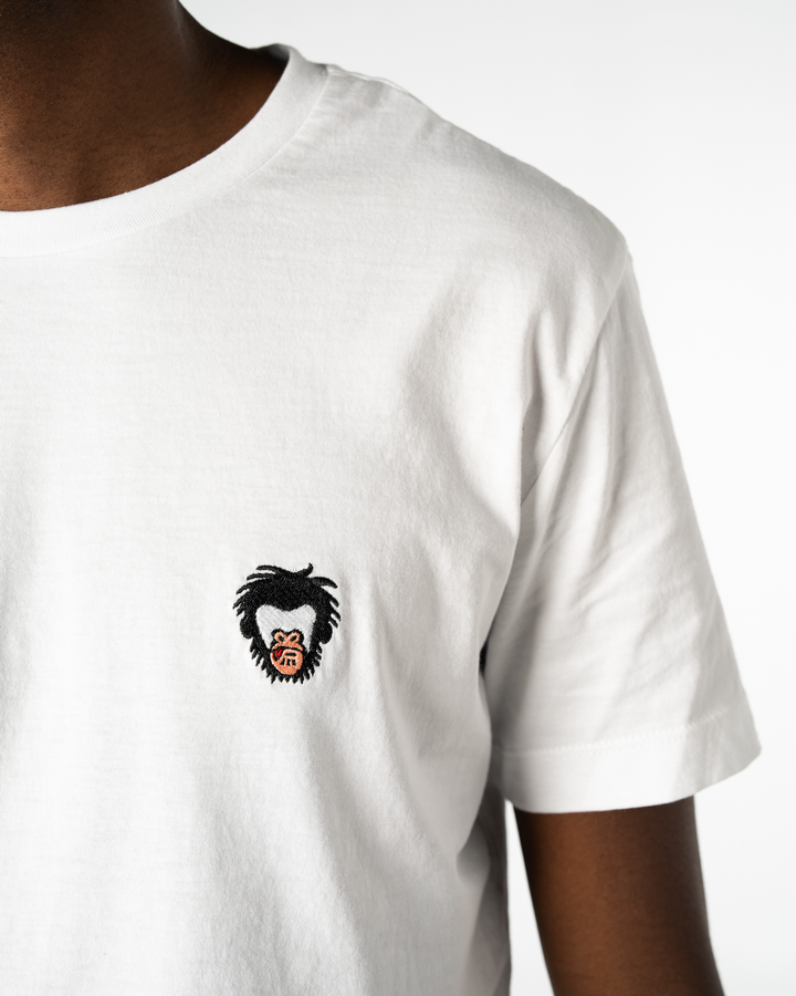White t-shirt with a graphic design on the chest against a white background #color_white