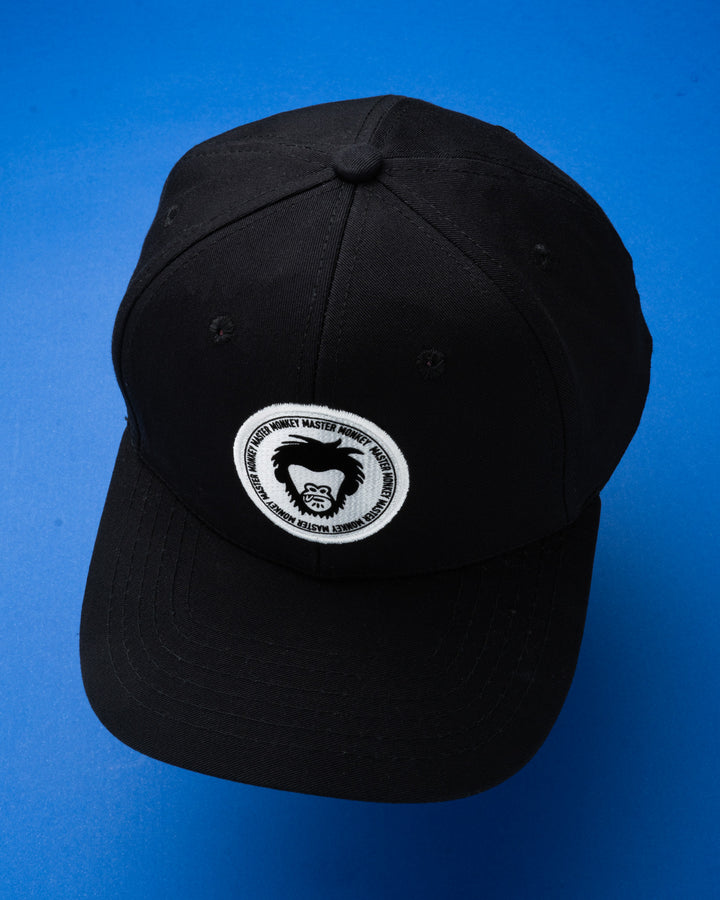 Black cap with a white logo on a blue background #color_black