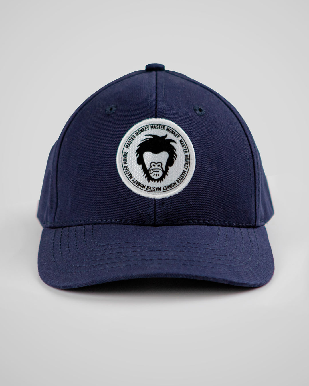 Navy blue cap with a circular logo featuring a monkey on a gray background #color_midnight